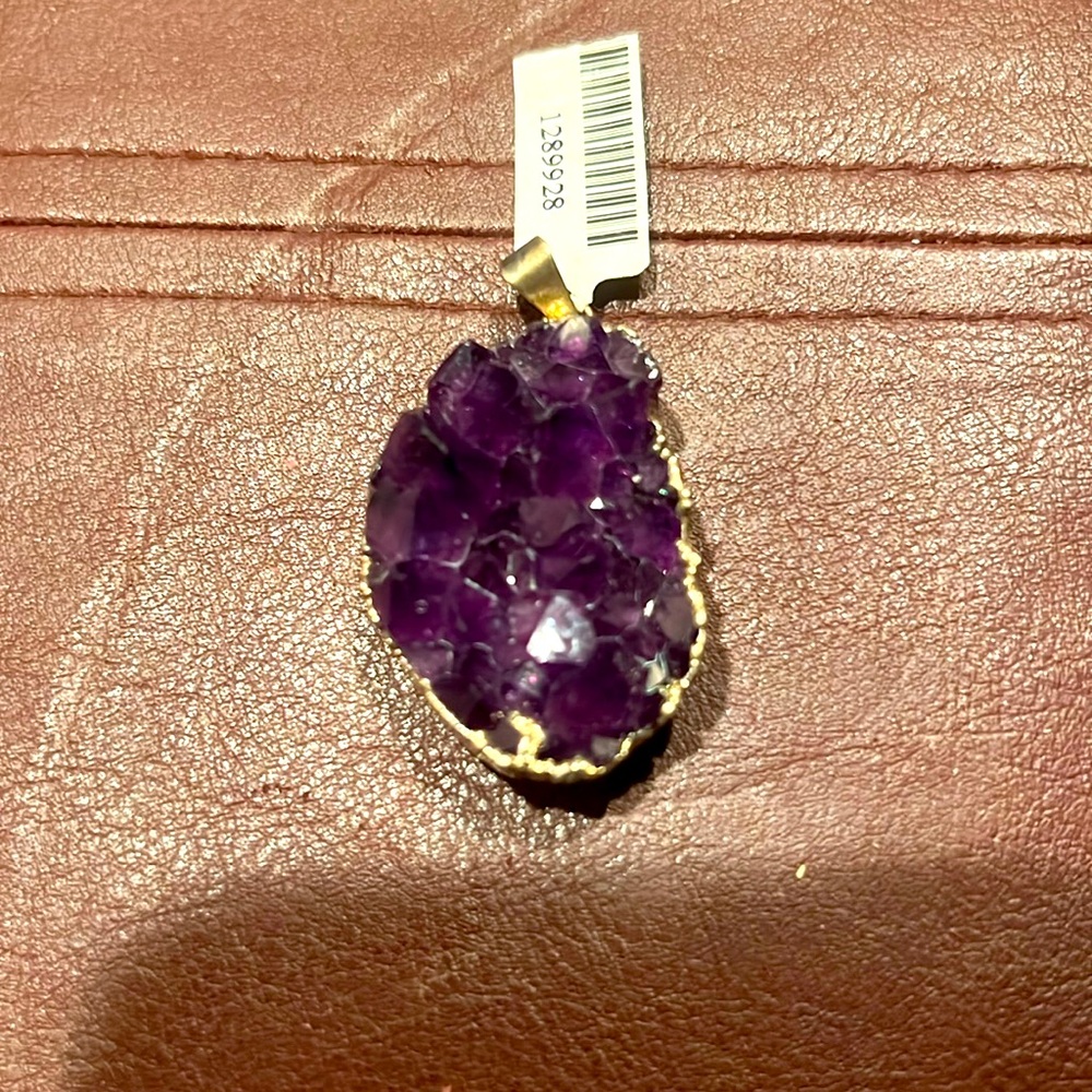 Natural amethyst nuggets in gold tone pendant.